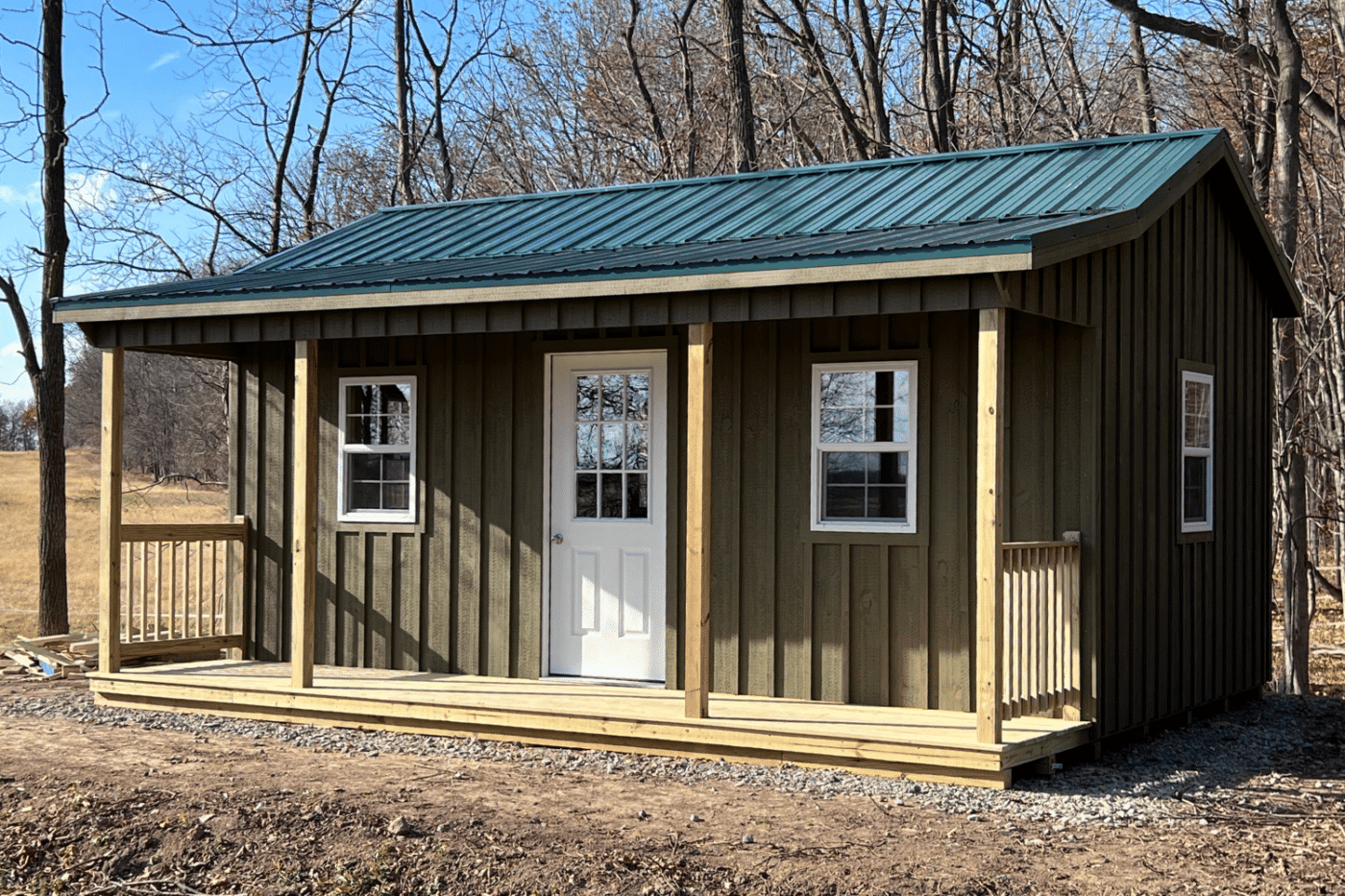 14x28 cabin with side porch and green metal roof in new york