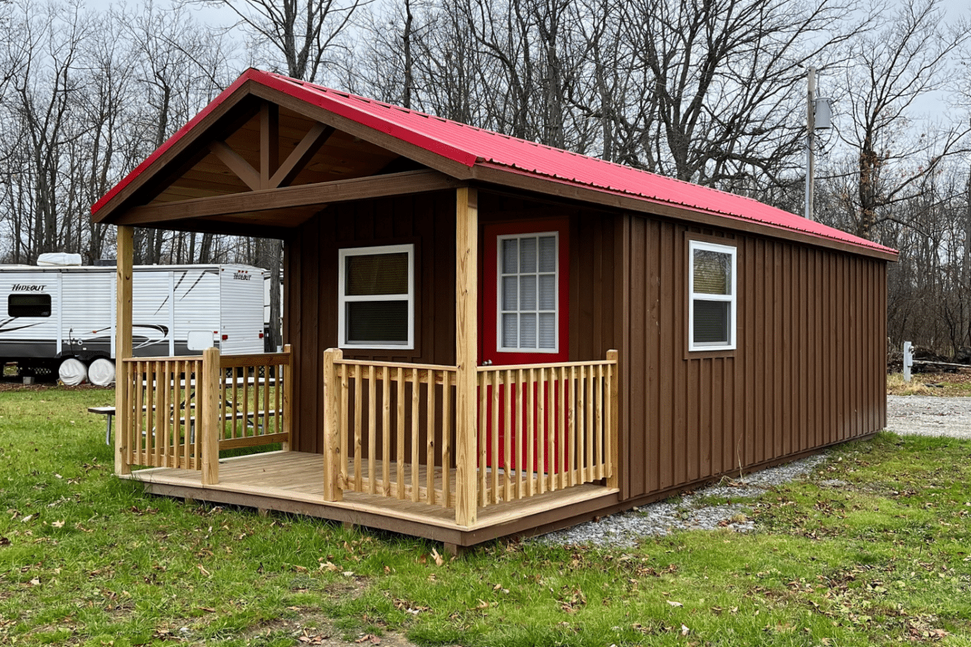 brown and red 12x14 cabin with a gable porch and windows in new york