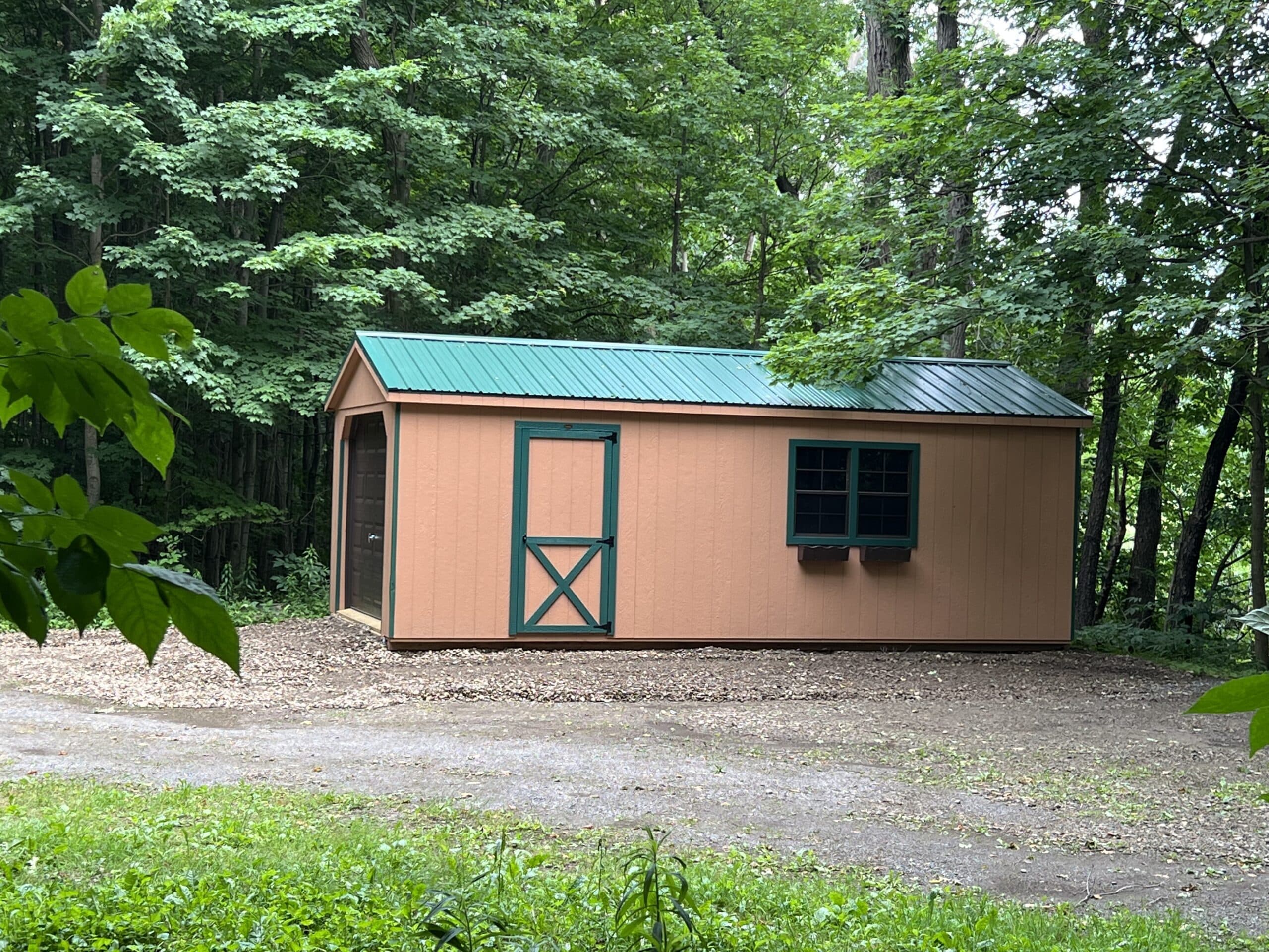 side view of 12x24 cottage garage in Warsaw NY with ivy trim and metal roof